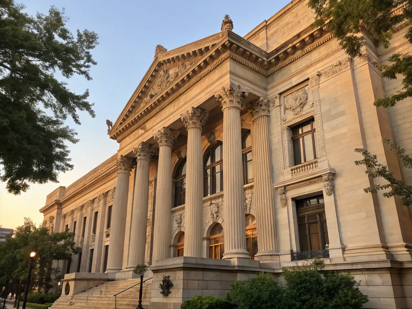 A photograph of the exterior of a classical-style library with large columns and arched windows, bathed in warm sunlight, suggesting a place of learning and discovery.